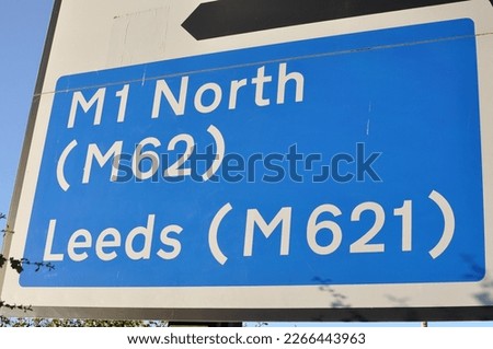 UK Motorway direction sign on a roundabout near Wakefield, West Yorkshire. The left hand lane goes to the M1 Motorway to the North via the M62 Motorway and Leeds via the M621 Motorway - 2019