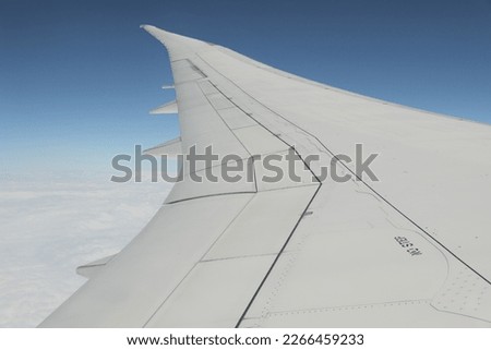 An airplane in the air. Royalty-Free Stock Photo #2266459233