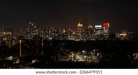 Atlanta City Skyline at Night with Skyscrapers and Buildings at Cloudy Twilight over the Trees in Georgia