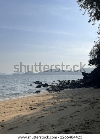 Sea of Thailand on the island of Phuket. Wave on the beach. Stones on the pool. Birch Sea. Mountains in the sea