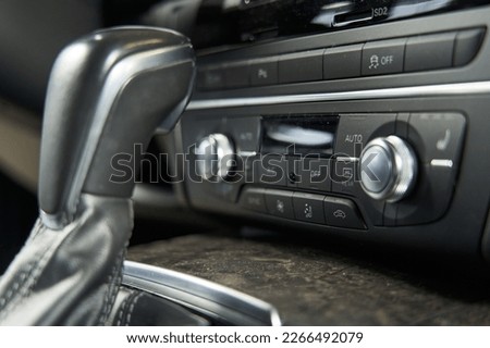 car climate control unit. buttons for air recirculation, turning off course stability, heated seats. knobs, knobs, buttons. gear lever Royalty-Free Stock Photo #2266492079