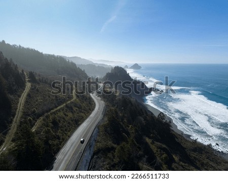 Afternoon sunlight shines on the southern coast of Oregon, along the Samuel H. Boardman State Scenic Corridor. This beautiful, rugged coastline is thickly forested and full of amazing viewpoints. Royalty-Free Stock Photo #2266511733