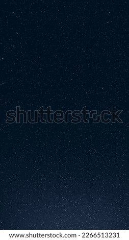 Natural Night Starry Sky. Amazing Glowing Stars And Meteoric Tracks Trail In Dark Night Starry Sky Background. Glowing Stars And Meteorite Trails.