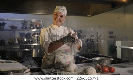 Chef woman preparing dough. Handling wheat flour. Background industrial kitchen.  Royalty-Free Stock Photo #2266515791