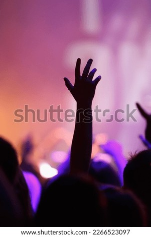 Cheerful music fan put hands up on concert. Electronic music festival audience partying to favorite DJ set