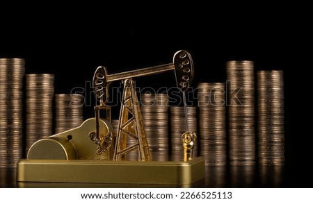 Golden oil pump against the background of columns of gold coins