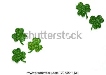 Happy St. Patrick's Day banner.Holiday background.St Patricks Day frame against a white background. Flat lay shamrocks.Copy space.Patrik's day banner Royalty-Free Stock Photo #2266544431
