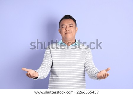 The 40s adult Asian man with standing on the purple background.