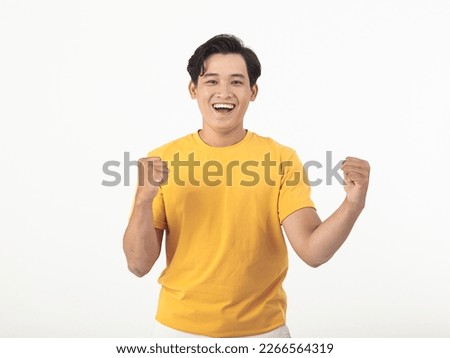 Portrait photo of a young happy cheerful handsome Asian man, yellow color casual wear, isolated on white background Royalty-Free Stock Photo #2266564319