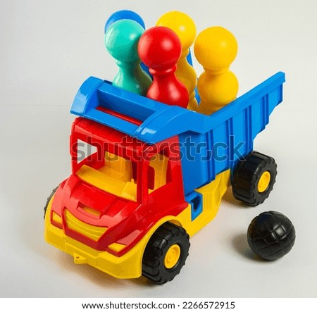 Children's toy multi-colored plastic truck on a white background.