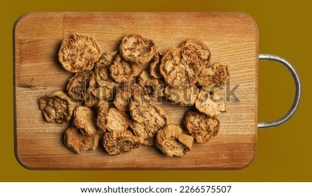 Dehydrated eggplants chunks background. Texture made of different heirlooms of dry aubergine. Vegetable chips.