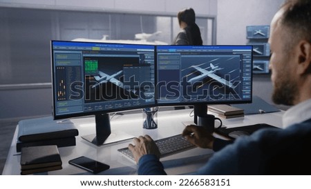 Engineers check aerodynamics of new development drone in laboratory for modern modifications using wind tunnel with steam. Computer system for changing parameters. Concept of manufacturing UCAVs. Royalty-Free Stock Photo #2266583151