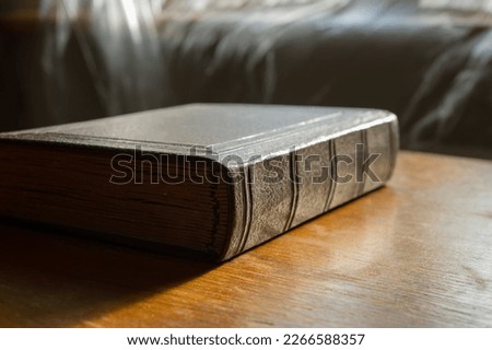 One closed old book lies on the table. Web banner.