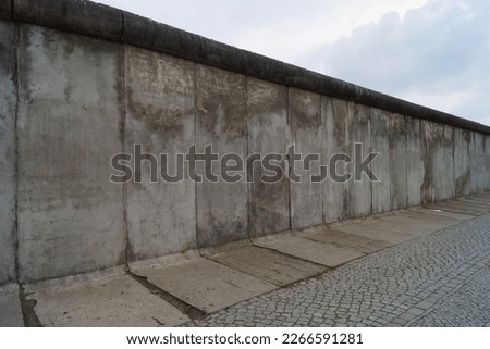 A powerful symbol of the Cold War, the Berlin Wall divided a city and a nation. This stock photo captures its iconic presence and historical significance