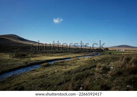Tarsaghaun is a hamlet in the Northern end of the parish Ballycroy, co. Mayo, on the threshold of the mountains as its name implies. It has no more than 3 farms on the Tarsaghaunmore river. Royalty-Free Stock Photo #2266592417