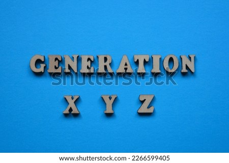 Generation X Y Z, word in wooden alphabet letters isolated on blue background as banner headline Royalty-Free Stock Photo #2266599405