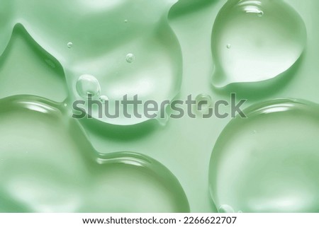Cosmetic green gel or lotion or hyaluronic acid transparent gel drops texture background