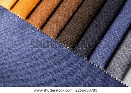 Bright collection of gunny textile samples. Multicolor fabric texture background. Samples of fabrics of different quality and category for furniture upholstery or curtains. Royalty-Free Stock Photo #2266630783