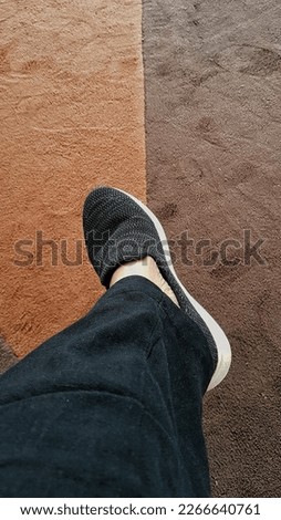 Photo of feet in the shoes  on the carpet background
