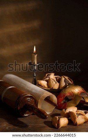 The Scroll of Esther and Purim Festival objects on a dark wooden table. Rustic.