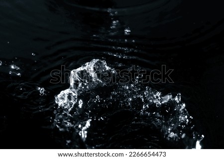 High speed of water splashing on black background