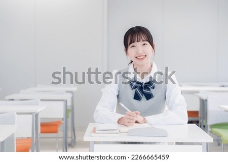 High school girls studying by themselves in a classroom Royalty-Free Stock Photo #2266665459