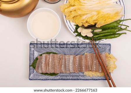 Table setting with makgeolli and skate ray sashimi