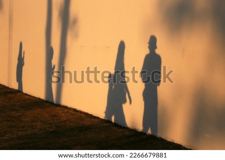 walking shadow man wall outdoor evening Royalty-Free Stock Photo #2266679881
