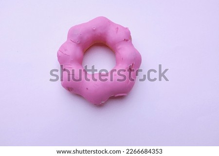 picture of a delicious round donuts with strawberry flavor isolated on pink pastel background.homemade bakery concept and snacks and drinks .