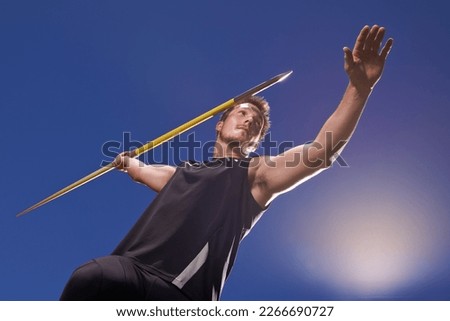 this is going the distance. Shot of a lone man throwing a javelin outside. Royalty-Free Stock Photo #2266690727