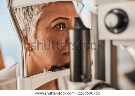 Medical, ophthalmology and eye test by patient senior woman with medical insurance using slit lamp. Mature, optometry and female doing vision or eyesight test in clinic using a machine Royalty-Free Stock Photo #2266690753