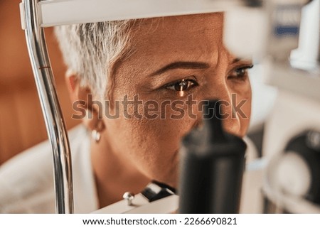 Laser, vision or senior customer in eye exam for eyesight at optometrist office in assessment or consultation. Face of mature woman testing or checking vision to help iris or retina visual health Royalty-Free Stock Photo #2266690821