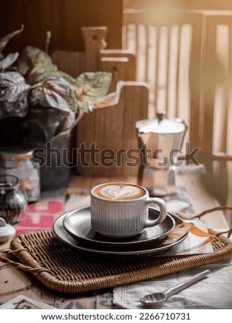 A cup of coffee lattee on the table. Conceptual stilllife photography with morning situations concept