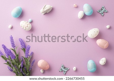 Easter celebration concept. Top view photo of colorful pink blue white easter eggs ceramic bunny butterflies and bouquet of lavender flowers on isolated lilac background with copyspace in the middle