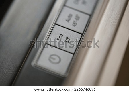 Close-up of eco button in a modern dishwasher control panel. Eco-friendly and energy-efficient household appliances. Royalty-Free Stock Photo #2266746091