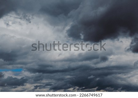 Summer cloudy dramatic rainy sky background. Panoramic view with beautiful clouds. Horizontal cloudscape. High-resolution photography. Design element. Selective focus. Copy space. 