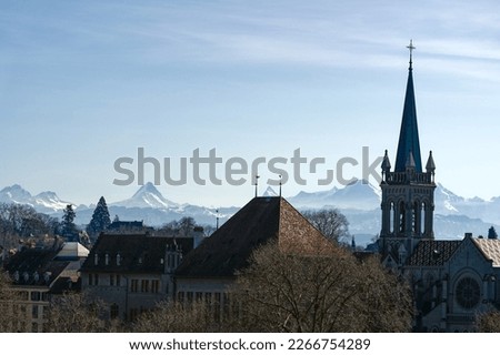 Scenic view of church St. Peter and Paul with the old town of Swiss City of Bern and Bernese Alps in the background on a blue cloudy winter day. Photo taken February 21st, 2023, Bern, Switzerland.