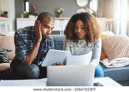 Stressed, worried and anxious couple doing finances, budget and internet banking. Upset couple looking at savings and online investment. Man and woman struggling with debt, loan and bond payment Royalty-Free Stock Photo #2266765307