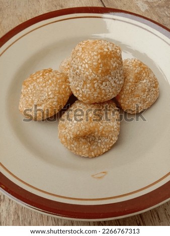 Round friedcake made of rice flourfilled filled with sweetened ground mung beans sprinkled with sesame seeds Royalty-Free Stock Photo #2266767313