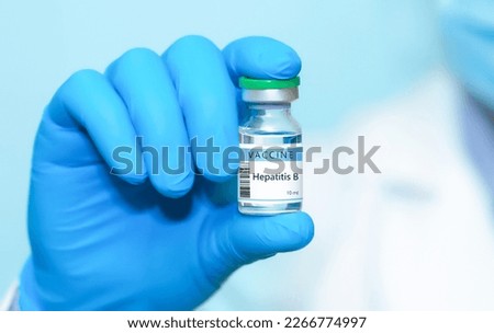 Doctor in protective gloves holding a hepatitis B vaccine . The concept of medicine, healthcare, science and vaccination awareness. Royalty-Free Stock Photo #2266774997