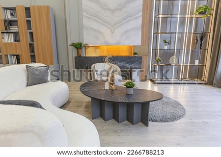 stylish luxury interior of modern studio apartment in green pastel colors with wooden elements. expensive furniture and decorations. cozy sitting area next to fireplace