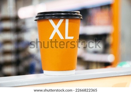 Close-up of disposable size xl cup of coffee on table	
