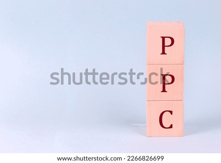 PPC on wooden cubes on blue background