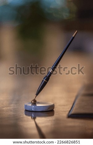 Fountain pen in a pen holder on an elegant wooden desk for ceremonies and business