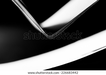 Black and white paper shapes. Image has grain texture visible on maximum size