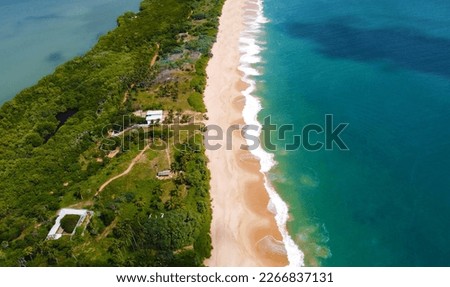 Aerial view of the long sandy tropical ocean shore. Beautiful tropical wallpapers for tourism and advertising. Asian landscape, drone photo