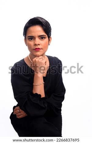 Confident young female lawyer with hand on chin. Isolated on white background.