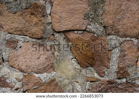 Wall made of stone, different shapes and colors. Close-up