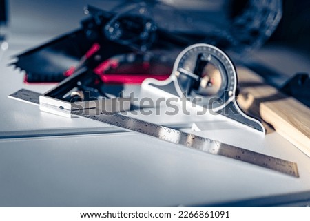 Ruler Multi Combination Square Angle Ruler and High Precision Protractor placed on the surface of a table saw with a piece of wood ready to be cut