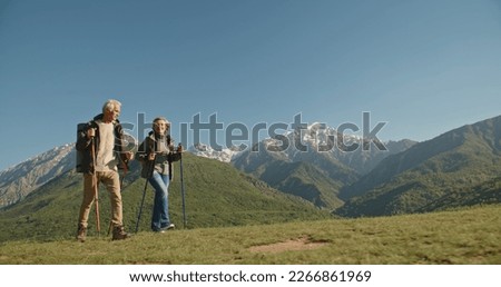 Mature caucasian couple on vacation, having a hike in spring mountains, spending time together after retirement together travelling - tourism, pension concept Royalty-Free Stock Photo #2266861969